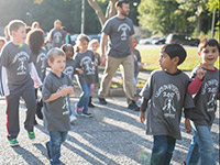 Children walking in Lights-On tshirts.